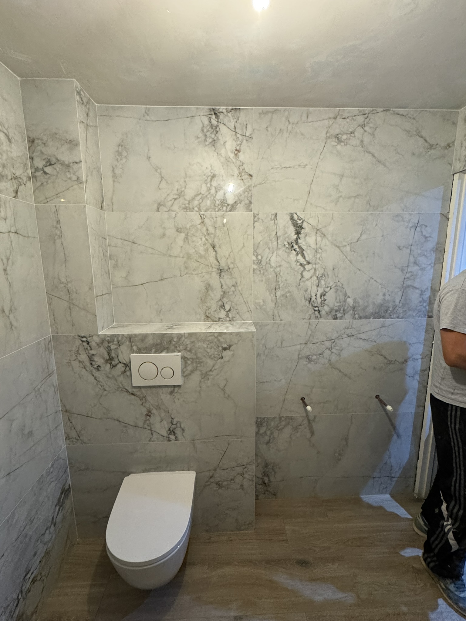 Wall-hung toilet and marble tiling, Swindon by Mark & Patryk Property Maintenance